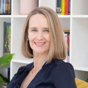 Photo of Sharon Peake sat in front of a book case